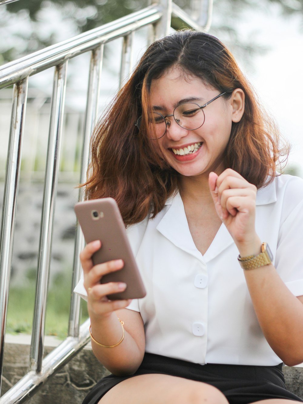 Woman smiling at her smartphone
