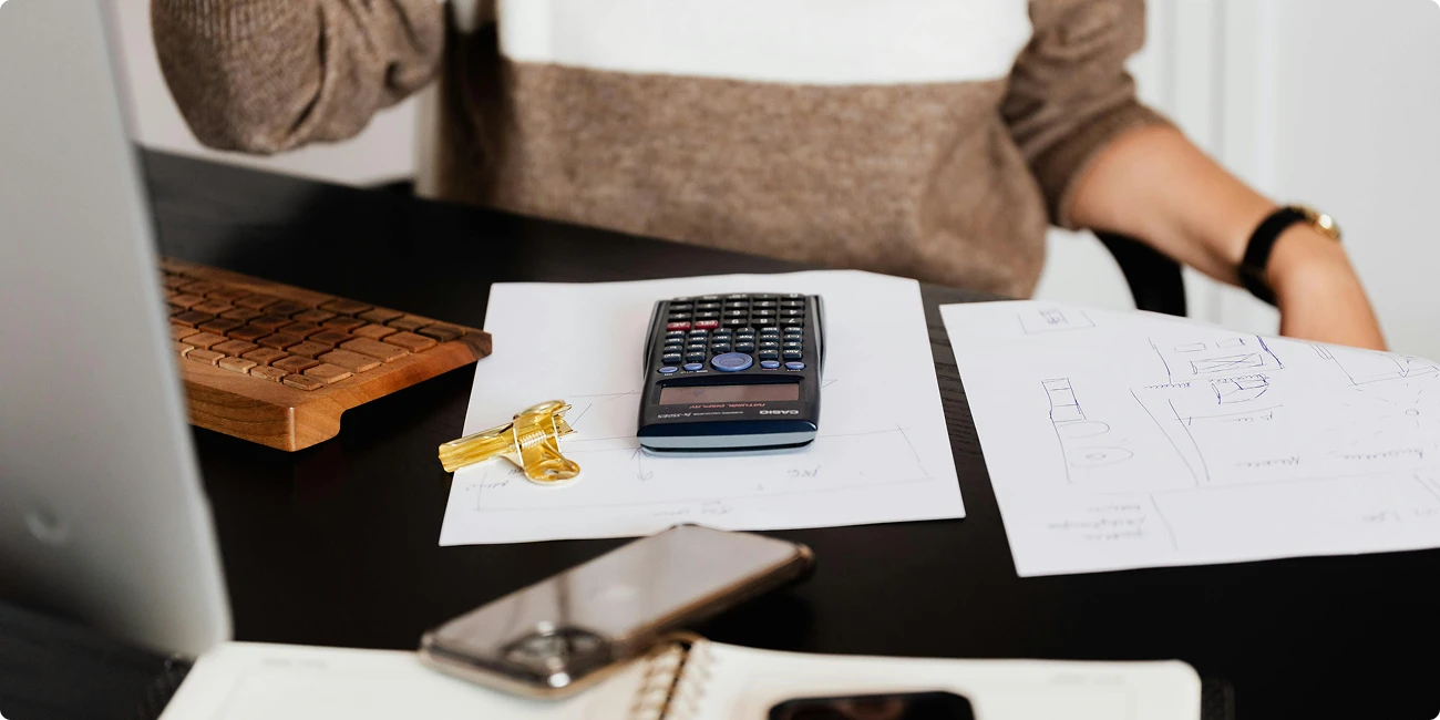 Calculator and papers on a desk